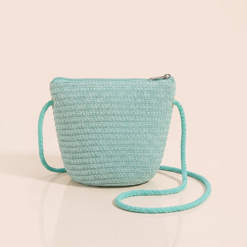 Girls green woven sling bag featuring yellow and orange floral applique