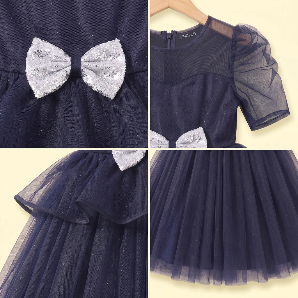 Girls navy blue party gown featuring puff sleeves and sequins