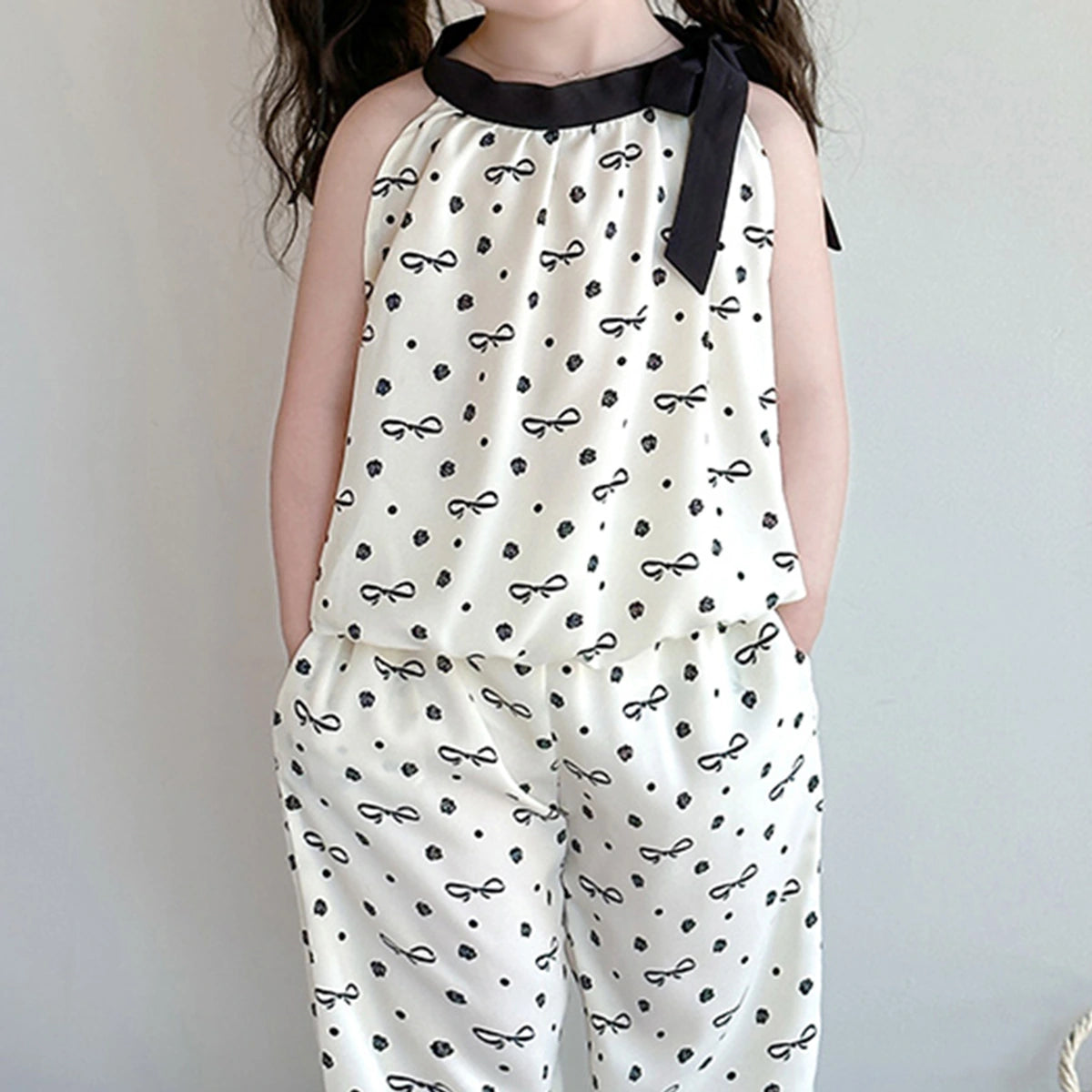 Girls Cream Bow Print Sleeveless Top With Elasticated Pants Sets Sets