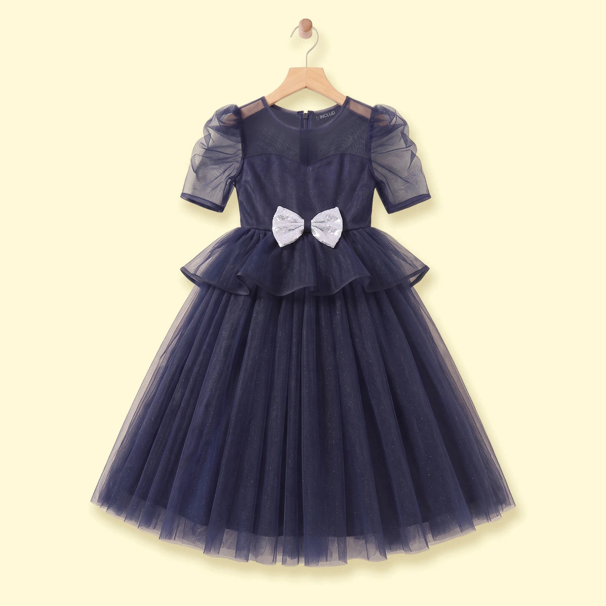 Girls navy blue party gown featuring puff sleeves and sequins