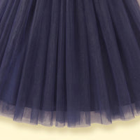 Girls navy blue party gown featuring puff sleeves and sequins