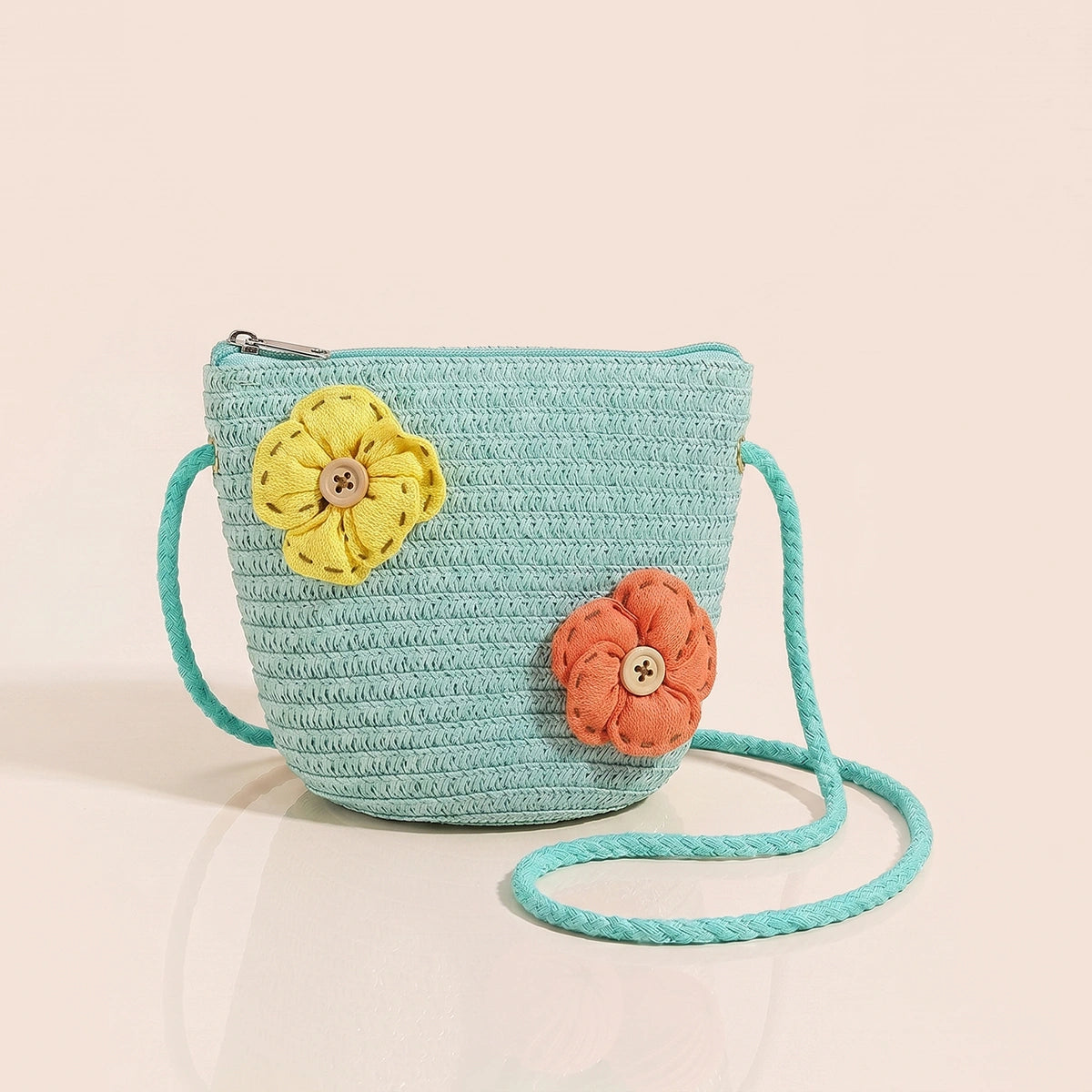 Girls green woven sling bag featuring yellow and orange floral applique