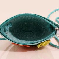 Girls green woven sling bag featuring yellow and orange floral applique